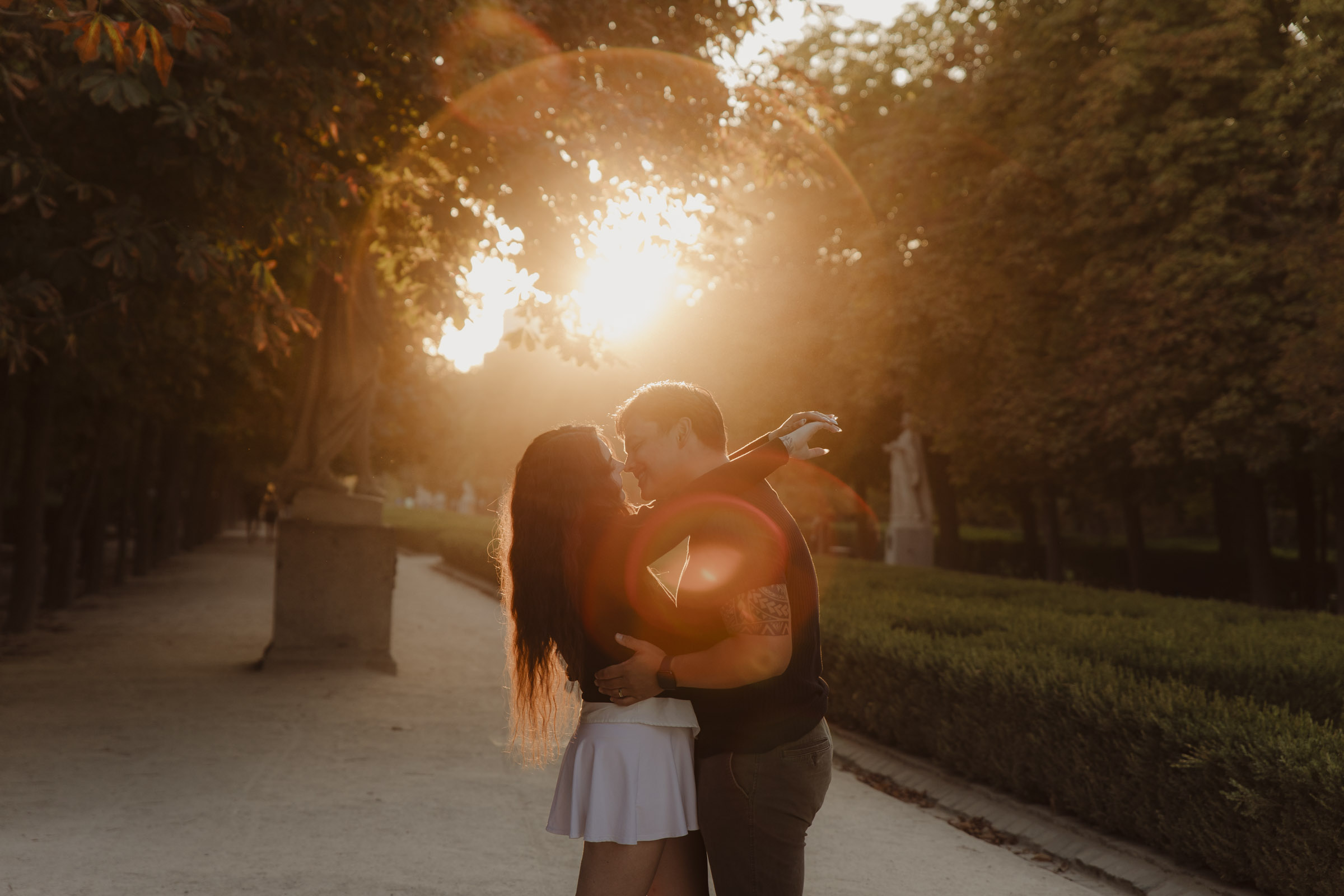 fotografia de pareja besandose en el parque del retiro con una luz de atardecer preciosa y romantica